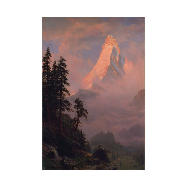 Mountain landscape at sunrise with warm hues and mist.