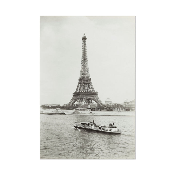 Black and white print of the Eiffel Tower beside the Seine River.