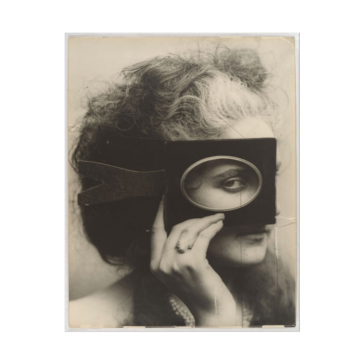 A woman holding a circular lens, captured in a haunting black-and-white image.