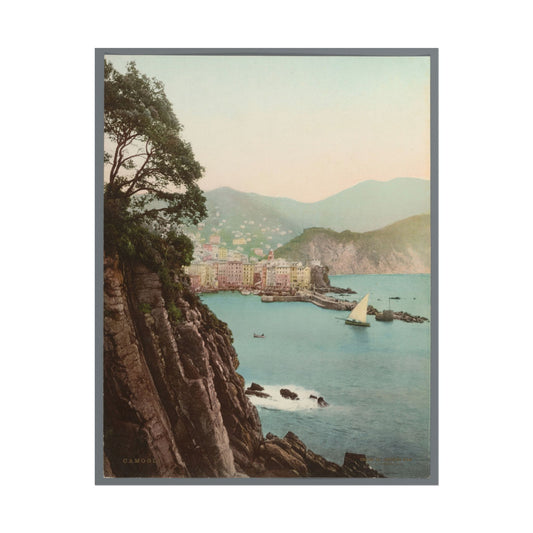 Scenic coastal view of Camogli, Italy, with cliffs and sailboats.