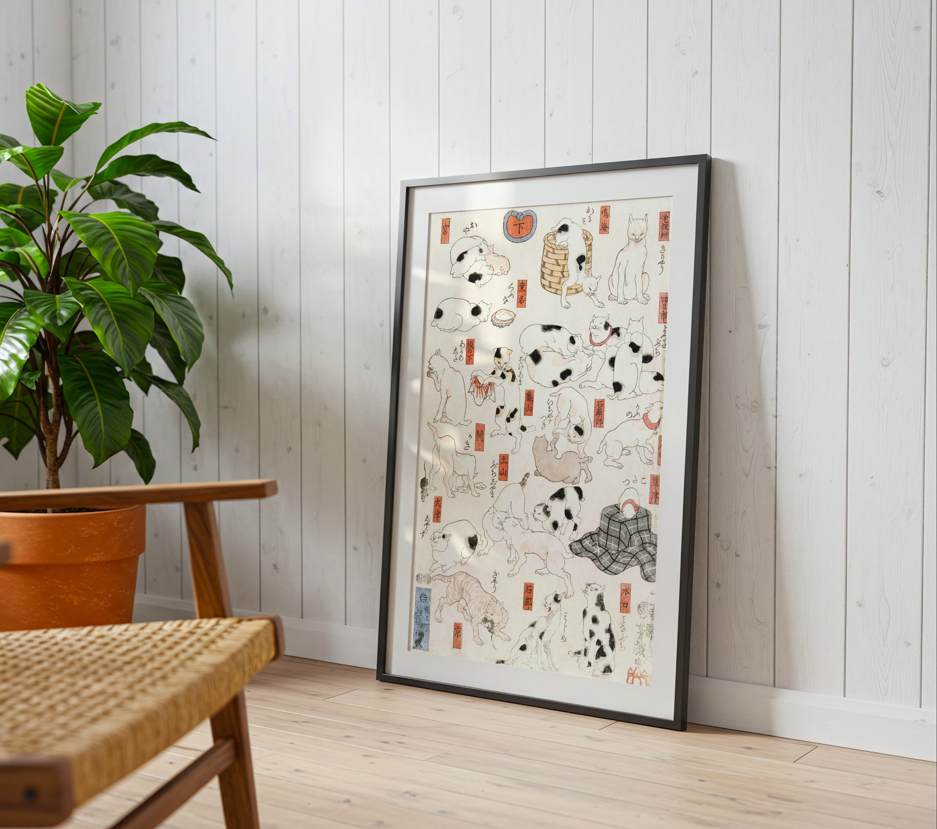 Cats woodblock print by Utagawa Kuniyoshi framed on a wall