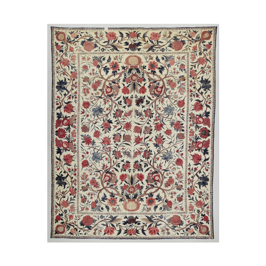 Intricate vintage floral textile design with red and blue flowers.