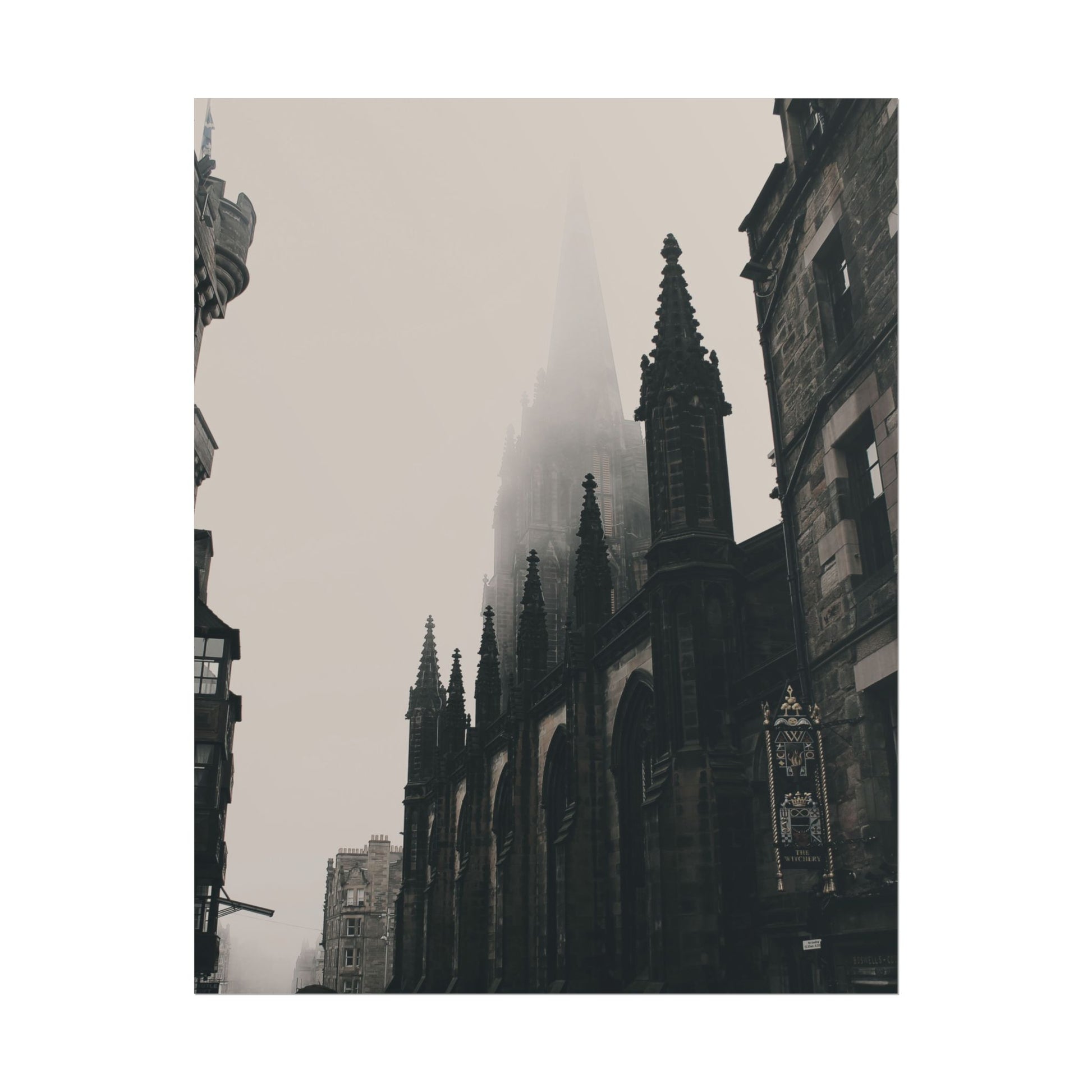 Misty view of a Gothic cathedral in Edinburgh with spires.