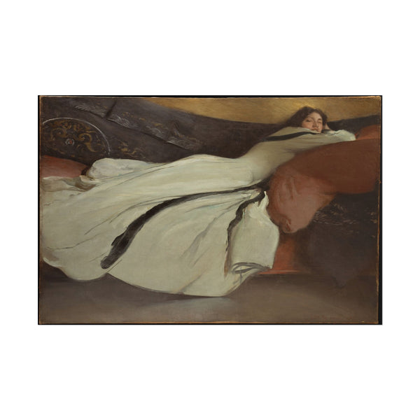 Woman in flowing gown resting gracefully on a soft background.