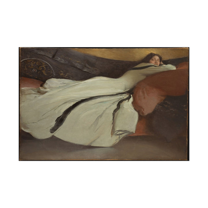 Woman in flowing gown resting gracefully on a soft background.