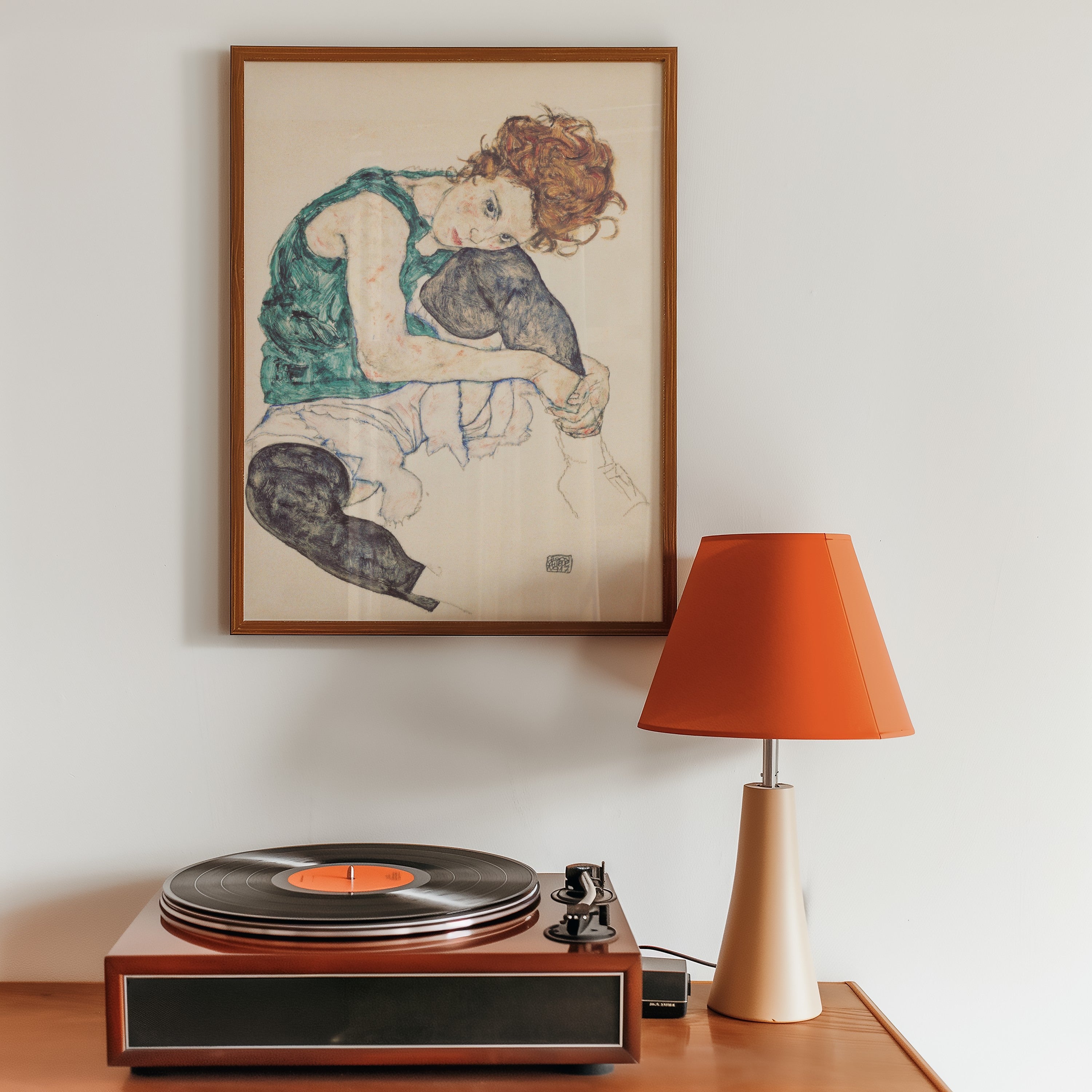 Seated Woman with Bent Knee by Egon Schiele displayed as framed wall art