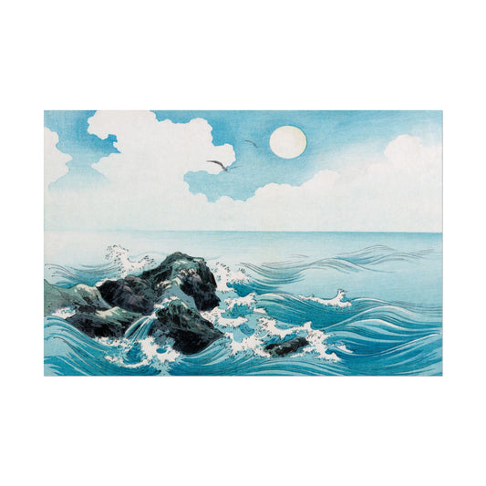 Ocean waves crashing on rocks under a bright sky.